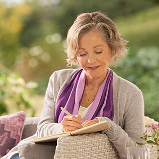 Woman writing in a notebook.